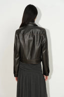 Back view of a black washed vegan leather fitted biker jacket with Western yoke seams and cropped silhouette