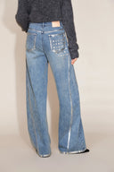 Women's light wash jeans with silver edged seams and star embellished back pockets