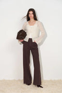 Cocoa brown wide leg utility jeans with shield shaped patch pockets styled with a sheer cream cardigan