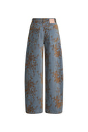 Women's barrel leg jeans in blue denim with a brown floral flocked jacquard pattern