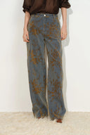 Gray flocked jacquard barrel leg jeans with a brown floral pattern and wide curved panels