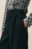Black pinstripe wide leg pants with a tied scarf waist and side pocket