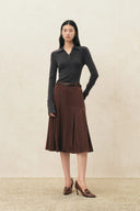 Black metallic button polo top styled with a brown midi skirt and brown leather heels