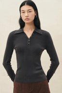 Black fitted stretch knit polo top with metallic buttons and sleeve accents