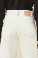 Fabrique ivory straight leg jeans with high waist, tonal stitching, and patch pockets