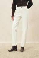 Ivory straight leg jeans with turned cuffs styled with a brown cardigan and ankle boots