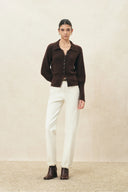 Ivory straight leg jeans styled with a brown cardigan and ankle boots
