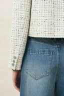 Cropped wool tweed jacket with a subtle shimmer check paired with blue jeans