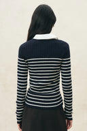 Navy and cream striped ribbed knit top with long sleeves and white collar, back view