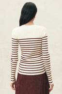 Back view of a cream and red striped ribbed knit top with long sleeves