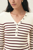 Cream and red striped knit henley top with long sleeves and buttoned V neck