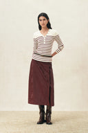 Model wearing a cream and burgundy striped henley knit top with long sleeves