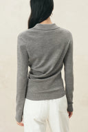 Gray cinched waist polo top in wool blend knit with long sleeves, shown from the back